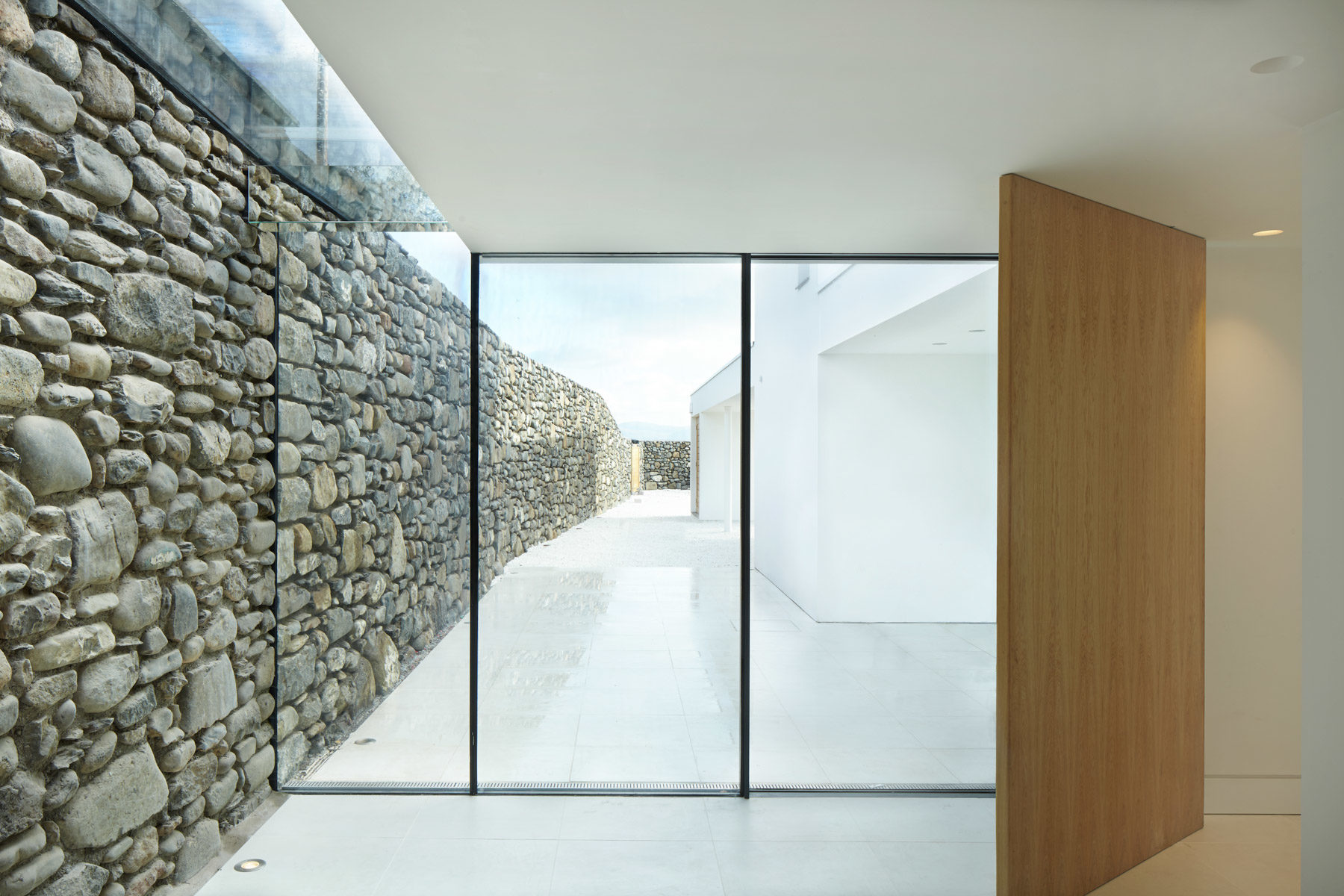 Skyframe sliding doors with structural frameless glass.